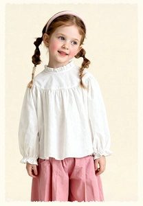 Detail of white cotton shirt for girls with ruffled collar and pleated chest design