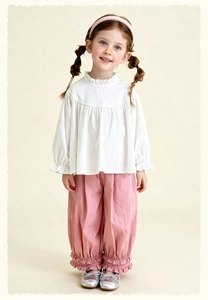 Detail of girls white ruffle collar shirt and pink bloomers outfit with sweet aesthetic