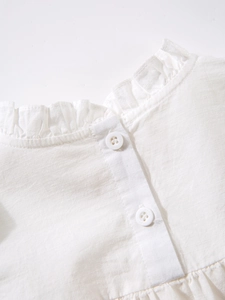 Girls' white cotton ruffle collar shirt with delicate front button closure detail