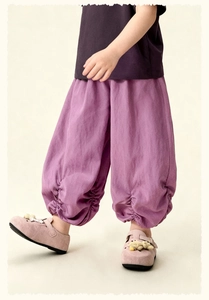 Detail of purple cotton linen joggers featuring pleated elastic cuffs for children