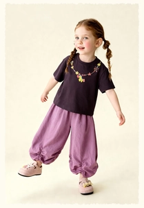 Detail of kids purple joggers with ruffled elastic cuffs and matching t-shirt