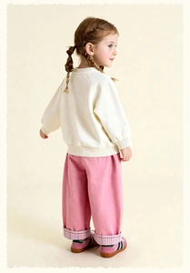 Detail of toddler sweatshirt and wide-leg pink pants with purple plaid cuffs