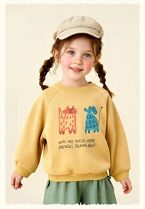 Detail of kids ginger yellow crewneck sweatshirt with cartoon cat and dog prints