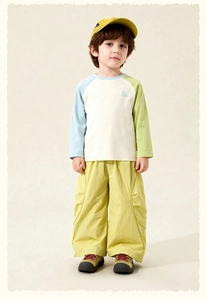 Detail of boys color-block long sleeve T-shirt and loose yellow cargo pants outfit