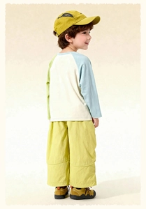 Detail of boys' two-piece set featuring color-block raglan t-shirt and lime casual pants