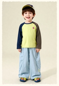 Detail of boys' yellow contrast sleeve T-shirt and light blue wide-leg cargo pants