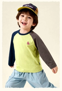 Detail of boys' raglan sleeve t-shirt and blue shorts with colorful baseball cap