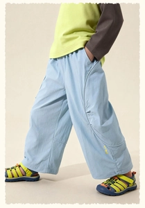 Detail of light blue wide-leg kids' joggers with sporty color-block fabric texture