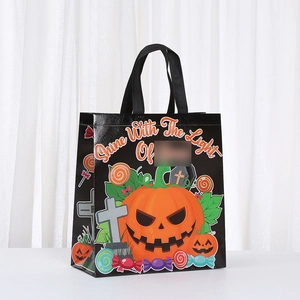 Halloween non-woven gift bag with pumpkin, bat and cross prints on a sturdy black tote