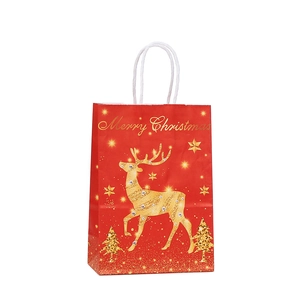 Red Christmas paper gift bag with golden reindeer and Merry Christmas print