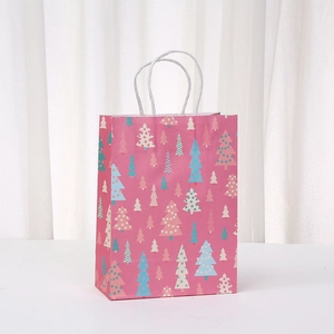 Pink Christmas paper gift bag with colorful tree prints and white twisted rope handles