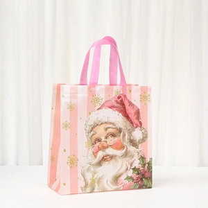 Detailed view of pink striped Christmas gift bag with retro Santa Claus and gold snowflakes