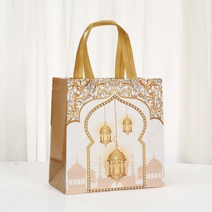 Elegant white Ramadan gift bag with gold mosque prints and handles for Eid celebrations
