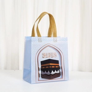 Light blue non-woven shopping bag with Kaaba illustration and golden woven handles