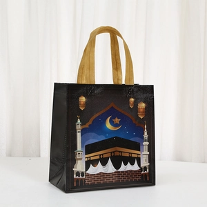 Black non-woven gift bag with gold moon and Kaaba illustration for Islamic festivals