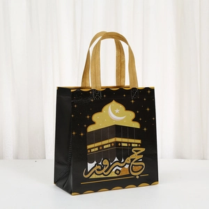 Islamic Hajj gift bag with golden Kaaba illustration and Arabic calligraphy on black base