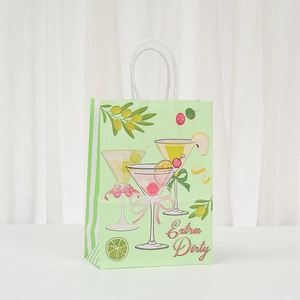 Close-up of light green paper gift bag with martini print and Extra Dirty text detail