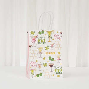 Cocktail themed kraft paper gift bag with martini prints and white braided handles