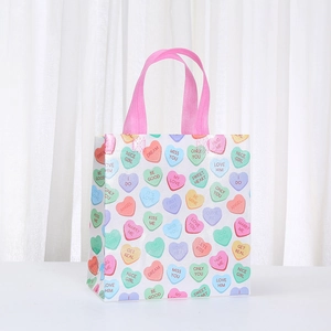 White waterproof non-woven gift bag with pink hearts and sweet english text prints