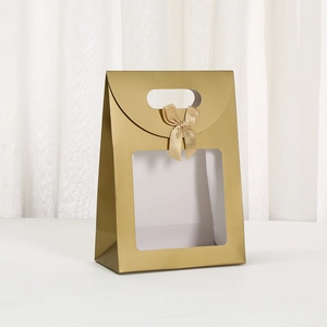 Matte gold trapezoid gift bag with clear window, handle and elegant satin bow