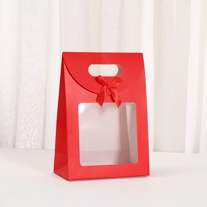 Detail of red gift box featuring a clear square window and a decorative silk bow tie
