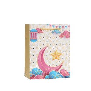 Festive gift bag with moon star lantern print and gold handle for holiday celebration