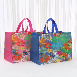 Laminated non-woven shopping bags with vibrant tropical floral prints and sturdy handles