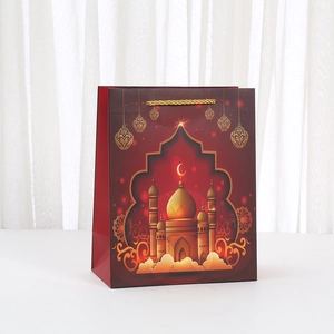 Deep burgundy festive paper gift bag with golden mosque and star patterns for Eid or Ramadan