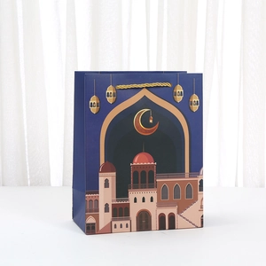 Navy blue Ramadan gift bag with gold moon and mosque illustration on white background