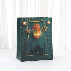 Green Ramadan gift paper bag with golden moon and mosque print and gold rope handles