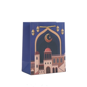 Blue Eid Mubarak gift bag with gold moon and mosque patterns and braided handles