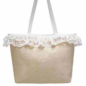 Lace-trimmed canvas tote bag in beige with white embroidery and top handles