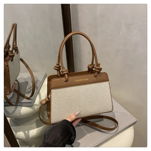 Detail of canvas leather tote bag with round knot handle and gold fashion lettering