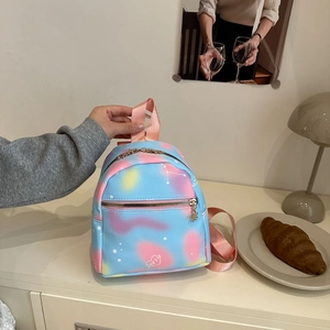 Mini backpack with blue and pink gradient star patterns and gold heart pendant