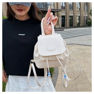 Dettaglio mini zaino bianco crema in pelle PU con coulisse di perline e logo