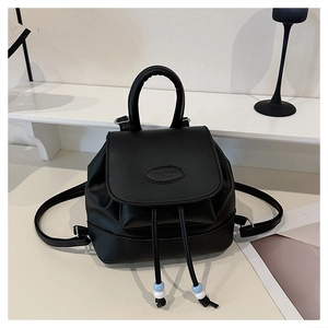 Detail of black leather mini backpack with Fautor logo, drawstring and bead accents