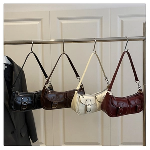 Four vintage underarm bags in black, dark coffee, white, and wine red with buckle detail
