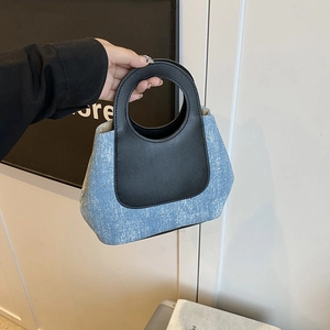 Contrast denim and black leather bucket handbag for casual daily use and commuting