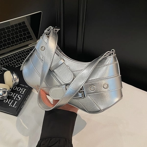 Metallic silver crescent underarm bag with biker buckles and Y2K aesthetic design