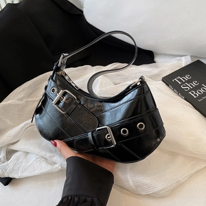 Minimalist black glossy half-moon underarm bag with silver buckles and grommet strap