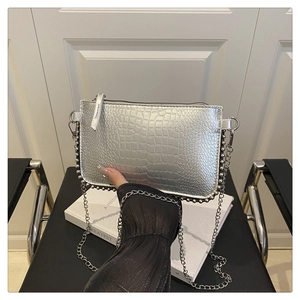Silver crocodile pattern handbag with metal bead trim and delicate chain strap details