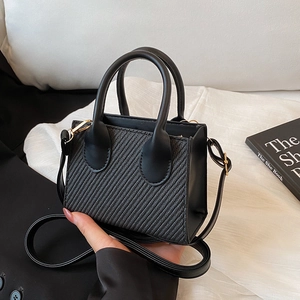 Chic black mini tote bag in woven fabric and leather with gold hardware for women