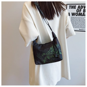 Detail of Crescent crossbody bag in Xiangyun silk with leaf pattern and adjustable strap