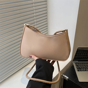 Minimalist beige half-moon underarm bag with smooth leather and gold hardware