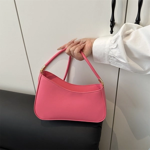 Minimalist rose pink crescent underarm bag in smooth synthetic leather with gold hardware