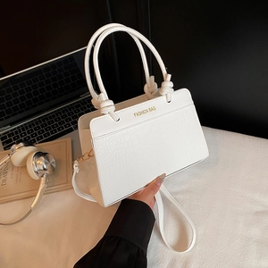 White crocodile pattern crossbody bag with double handles and fashion bag text detail