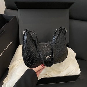 French style black woven shoulder bag with silver bow accent and elegant gift packaging