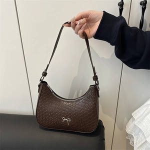 Brown woven hobo bag with silver bow detail and adjustable shoulder strap for women