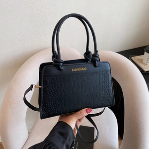 Chic black crocodile embossed handbag with gold lettering and knotted handle detail