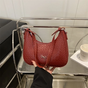 Red woven texture hobo bag featuring a silver metal bow accent and a matching leather strap